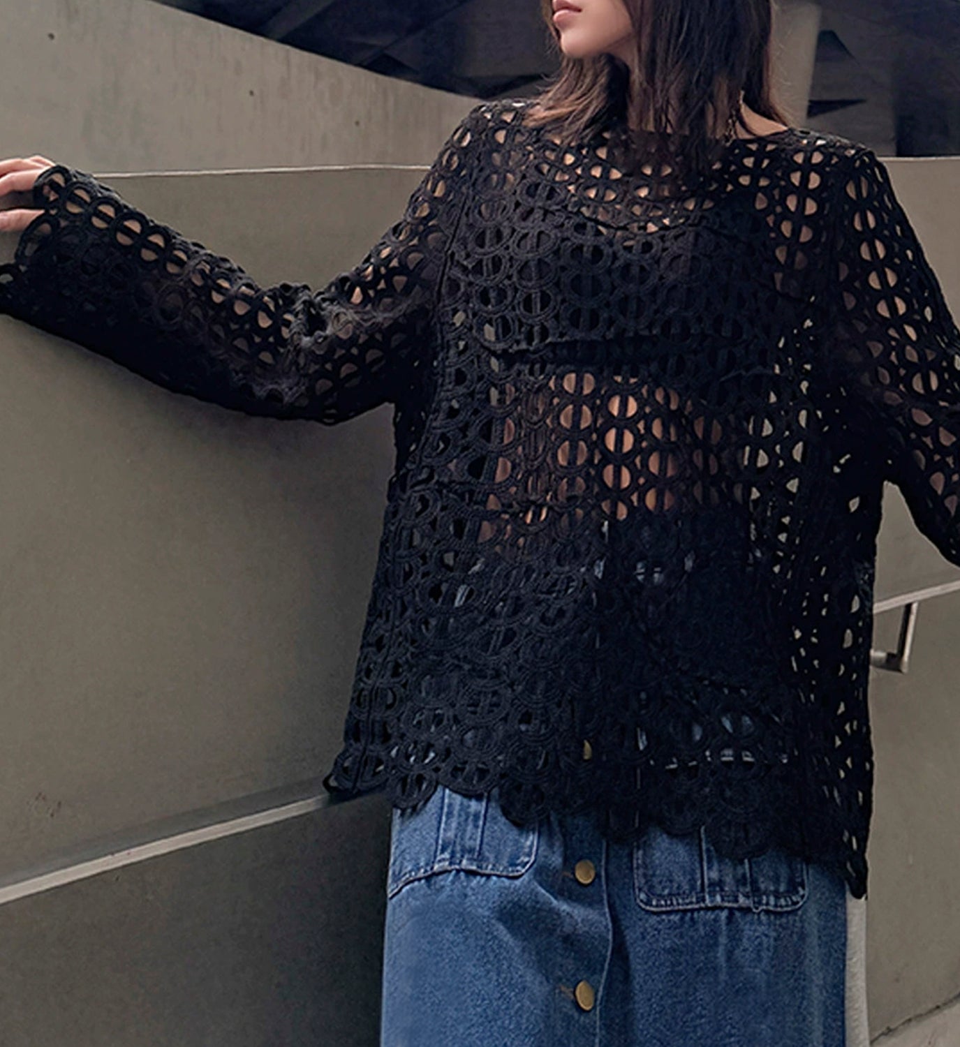 Elegant black cut-out lace top from DIGS, featuring intricate lace details and a stylish design perfect for fashionable occasions.