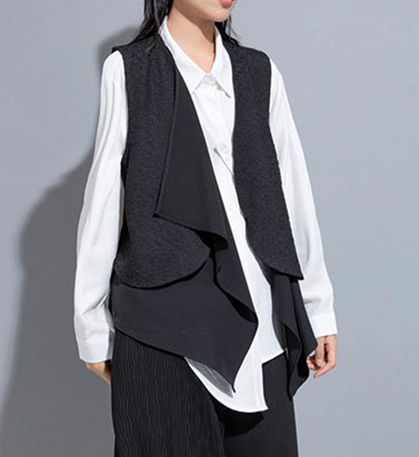 Layered DIGS vest with multiple fabric layers, featuring a stylish design and front pockets, perfect for casual wear.