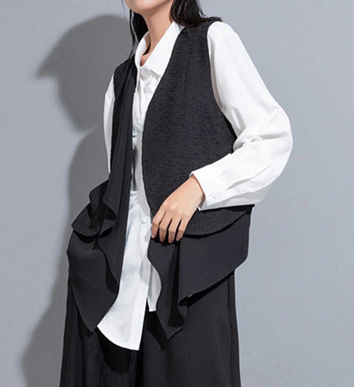 Layered DIGS vest with multiple fabric layers, showcasing a stylish and versatile VEST design on a neutral background.