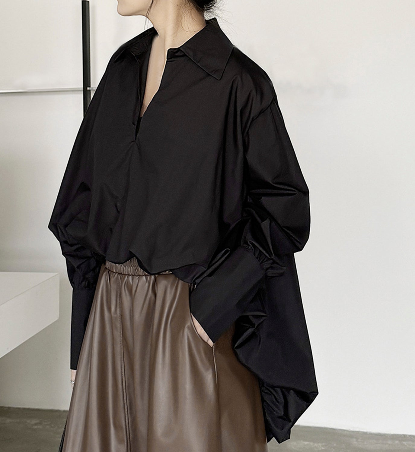 Digs hi-lo shirred shirt featuring a relaxed fit and gathered detailing, shown in a casual style on a model.